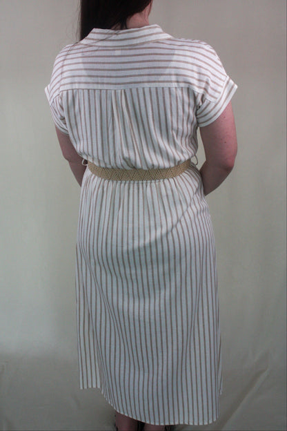Person wearing a white and khaki striped dress with a belt against a plain background